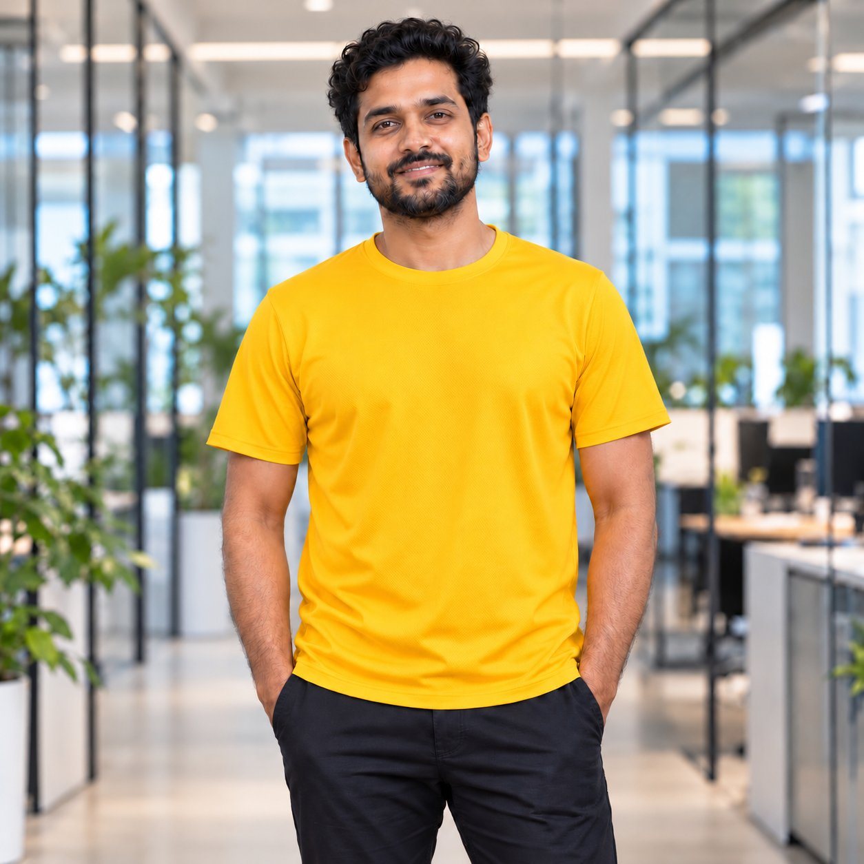 Click to zoom Golden Yellow Airdry Round Neck T-Shirt customised with your company logo, worn by a man in a modern office. Custom logo T-shirt for corporate gifting.