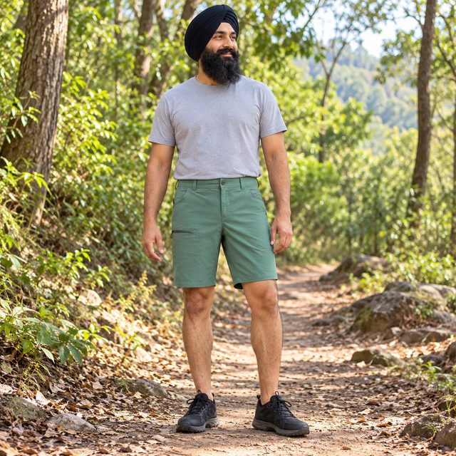Man wearing Decathlon Men's Hiking Shorts NH500 in Green, bulk order with company logo