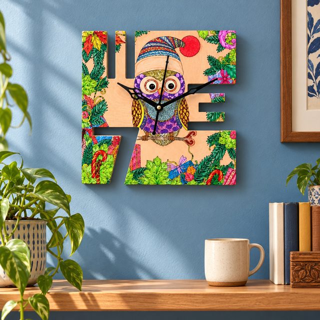 Wooden Wall Clock with Meena Artwork, shown in use